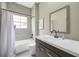 Modern bathroom with gray tiled shower, sleek vanity, and updated fixtures at 10130 Deercliff Dr, Tampa, FL 33647