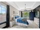 Comfortable bedroom featuring tray ceiling, generous windows, and elegant fixtures at 10130 Deercliff Dr, Tampa, FL 33647