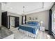 Stylish bedroom with tray ceiling, chandelier, and access to ensuite bathroom at 10130 Deercliff Dr, Tampa, FL 33647