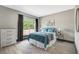 This bedroom features a large window providing natural light, complemented by gray walls and wood-look flooring at 10130 Deercliff Dr, Tampa, FL 33647
