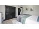 View of the bedroom, featuring a closet with black doors, gray walls, and light-colored wood laminate flooring at 10130 Deercliff Dr, Tampa, FL 33647