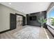A spacious bonus room with a large window and stylish black accent wall, perfect for entertainment at 10130 Deercliff Dr, Tampa, FL 33647
