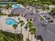 An aerial view of a clubhouse with pools, palm trees and well manicured landscaping at 10130 Deercliff Dr, Tampa, FL 33647