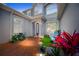 Inviting courtyard featuring a red brick walkway, green space, and cozy seating, creating an inviting entrance at 10130 Deercliff Dr, Tampa, FL 33647