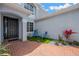 Private courtyard with seating and brick pathway leading to the front door offering a tranquil outdoor space at 10130 Deercliff Dr, Tampa, FL 33647
