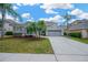 Beautiful two-story home showcasing a well-manicured lawn, lush landscaping, and inviting curb appeal at 10130 Deercliff Dr, Tampa, FL 33647