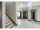 Grand foyer with soaring ceilings, a staircase, and marble floors leading to the main living areas at 10130 Deercliff Dr, Tampa, FL 33647