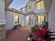 Landscaped front yard, with flowering garden area on brick pathway leading to front door and covered entryway at 10130 Deercliff Dr, Tampa, FL 33647