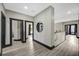 Bright hallway boasts gray walls, black trim and doors, and wood-look flooring with natural light, a modern and welcoming space at 10130 Deercliff Dr, Tampa, FL 33647