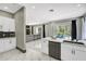 Open kitchen with white marble floors and a view of the open living area with modern decor at 10130 Deercliff Dr, Tampa, FL 33647