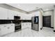 Well-equipped kitchen with modern stainless steel appliances, sleek white cabinetry, and subway tile backsplash at 10130 Deercliff Dr, Tampa, FL 33647