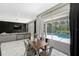 Open concept living and dining area with modern decor and sliding doors to the backyard pool at 10130 Deercliff Dr, Tampa, FL 33647