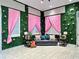 Whimsical sitting room with artificial garden walls, pink curtains, and tile floors at 10130 Deercliff Dr, Tampa, FL 33647