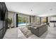 Bright living room with an open floor plan, contemporary furnishings, and a view of the backyard pool at 10130 Deercliff Dr, Tampa, FL 33647