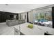 Open concept living room with modern decor and view of the backyard pool area at 10130 Deercliff Dr, Tampa, FL 33647