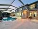Backyard pool area with a screened-in lanai, dining space, and view into the home at 10130 Deercliff Dr, Tampa, FL 33647