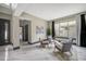 Stylish sitting room with comfortable gray armchairs, a round table, and elegant decor at 10130 Deercliff Dr, Tampa, FL 33647