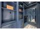 Well-appointed walk-in closet with custom shelving and drawers in a stunning navy finish at 10130 Deercliff Dr, Tampa, FL 33647