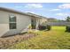 View of the backyard, patio with sliding door, and landscaping at 10229 Bright Crystal Ave, Riverview, FL 33578