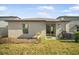 View of the backyard, patio with sliding door, and landscaping at 10229 Bright Crystal Ave, Riverview, FL 33578