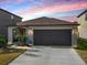 Charming one-story home featuring a two-car garage, manicured lawn, and welcoming front entrance at 10229 Bright Crystal Ave, Riverview, FL 33578