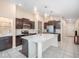 Modern kitchen featuring a large island with stone countertops and stainless steel appliances at 10229 Bright Crystal Ave, Riverview, FL 33578