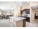 Modern kitchen featuring a large island with stone countertops and stainless steel appliances at 10229 Bright Crystal Ave, Riverview, FL 33578