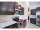 Modern kitchen featuring a large island with stone countertops and stainless steel appliances at 10229 Bright Crystal Ave, Riverview, FL 33578