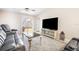 Comfortable living room with plush seating, a ceiling fan, and sliding doors to the backyard at 10229 Bright Crystal Ave, Riverview, FL 33578