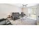 Comfortable living room with plush seating, a ceiling fan, and sliding doors to the backyard at 10229 Bright Crystal Ave, Riverview, FL 33578
