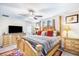 Spacious main bedroom with a ceiling fan, bedside tables, and large windows at 10229 Bright Crystal Ave, Riverview, FL 33578