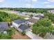 Aerial view showcases a neighborhood with a home featuring a driveway and mature trees at 10308 Boyette Creek Blvd, Riverview, FL 33569