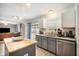 An updated kitchen features granite countertops, stainless steel appliances, island and bar sink at 10308 Boyette Creek Blvd, Riverview, FL 33569
