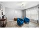 Living room featuring wood flooring, curtains and a small seating area with dark blue chairs at 10308 Boyette Creek Blvd, Riverview, FL 33569