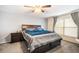 Spacious main bedroom featuring a ceiling fan, a window, neutral carpet and a large sleigh bed with built-in storage drawers at 10308 Boyette Creek Blvd, Riverview, FL 33569