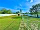 Spacious backyard featuring a fence, a storage building and a clear blue sky at 11268 Shivering Owl Ave, Weeki Wachee, FL 34614