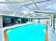 Beautiful backyard featuring a pool with screened enclosure, patio area, and a lush, well-maintained outdoor space at 11268 Shivering Owl Ave, Weeki Wachee, FL 34614