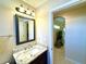 Bathroom featuring granite countertop vanity, updated lighting, and a view to the next room at 11268 Shivering Owl Ave, Weeki Wachee, FL 34614
