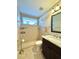 Bright bathroom featuring a walk-in shower with tiled walls and a granite topped vanity at 11268 Shivering Owl Ave, Weeki Wachee, FL 34614