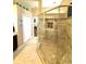 Bathroom shower featuring a glass walk-in shower with bench and spa-like finishes at 11268 Shivering Owl Ave, Weeki Wachee, FL 34614