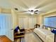 Bedroom showcases wood floors, ceiling fan, daybed, and comfortable furnishings at 11268 Shivering Owl Ave, Weeki Wachee, FL 34614