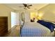 Spacious bedroom with ceiling fan, wood floors, and view of walk-in closet at 11268 Shivering Owl Ave, Weeki Wachee, FL 34614