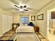 Bright bedroom featuring wood floors, a ceiling fan, and quaint decor at 11268 Shivering Owl Ave, Weeki Wachee, FL 34614