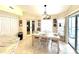Cozy dining area adjacent to the kitchen with a sliding glass door leading to the pool area at 11268 Shivering Owl Ave, Weeki Wachee, FL 34614