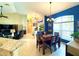 Dining area with blue accent wall next to living room at 11268 Shivering Owl Ave, Weeki Wachee, FL 34614