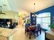 Open-concept dining area featuring a chandelier, blue accent wall, and seamless flow to the living spaces at 11268 Shivering Owl Ave, Weeki Wachee, FL 34614