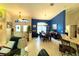 Dining area with a blue accent wall, chandelier, and a view of the front entrance at 11268 Shivering Owl Ave, Weeki Wachee, FL 34614
