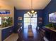 Elegant dining room features a dark wood table and chairs with a decorative chandelier and large window at 11268 Shivering Owl Ave, Weeki Wachee, FL 34614