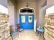 Charming front porch with colorful doors and decorative accents at 11268 Shivering Owl Ave, Weeki Wachee, FL 34614