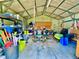 Organized garage interior with a variety of tools and equipment at 11268 Shivering Owl Ave, Weeki Wachee, FL 34614